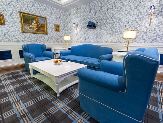 Two chairs and a sofa placed around a coffee table in the living room - The Manor Luxury Hotel, Shimla