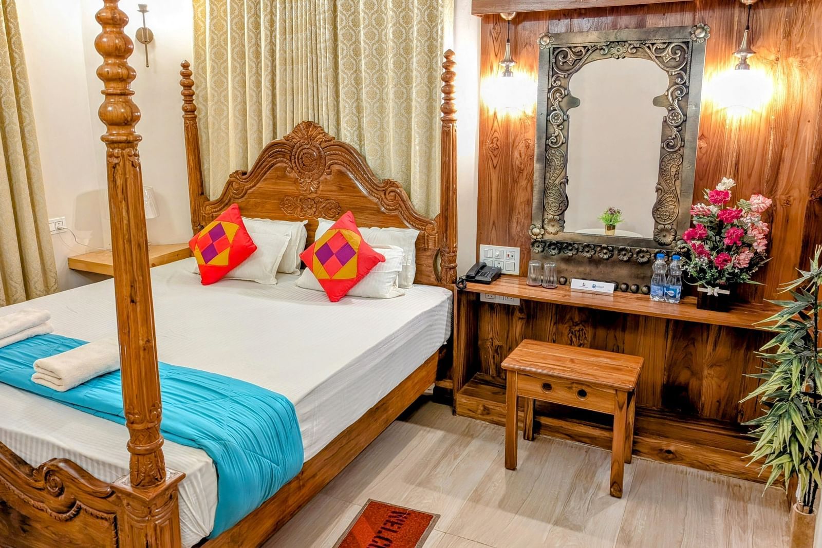 A double bed at the pool side cottage at dip holidays along with a dressing table besides it