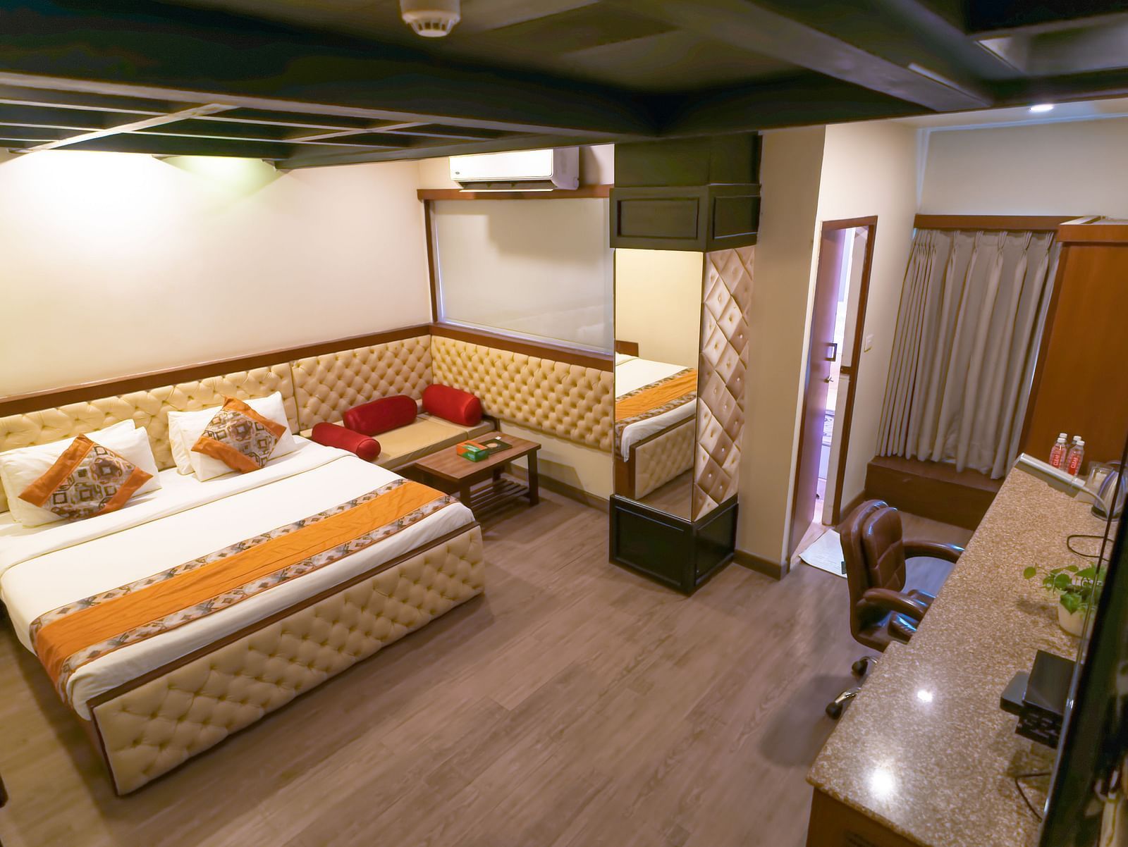 A view of the Deluxe Room featuring a bed with wooden interior at Hotel Ashok Nagpur.