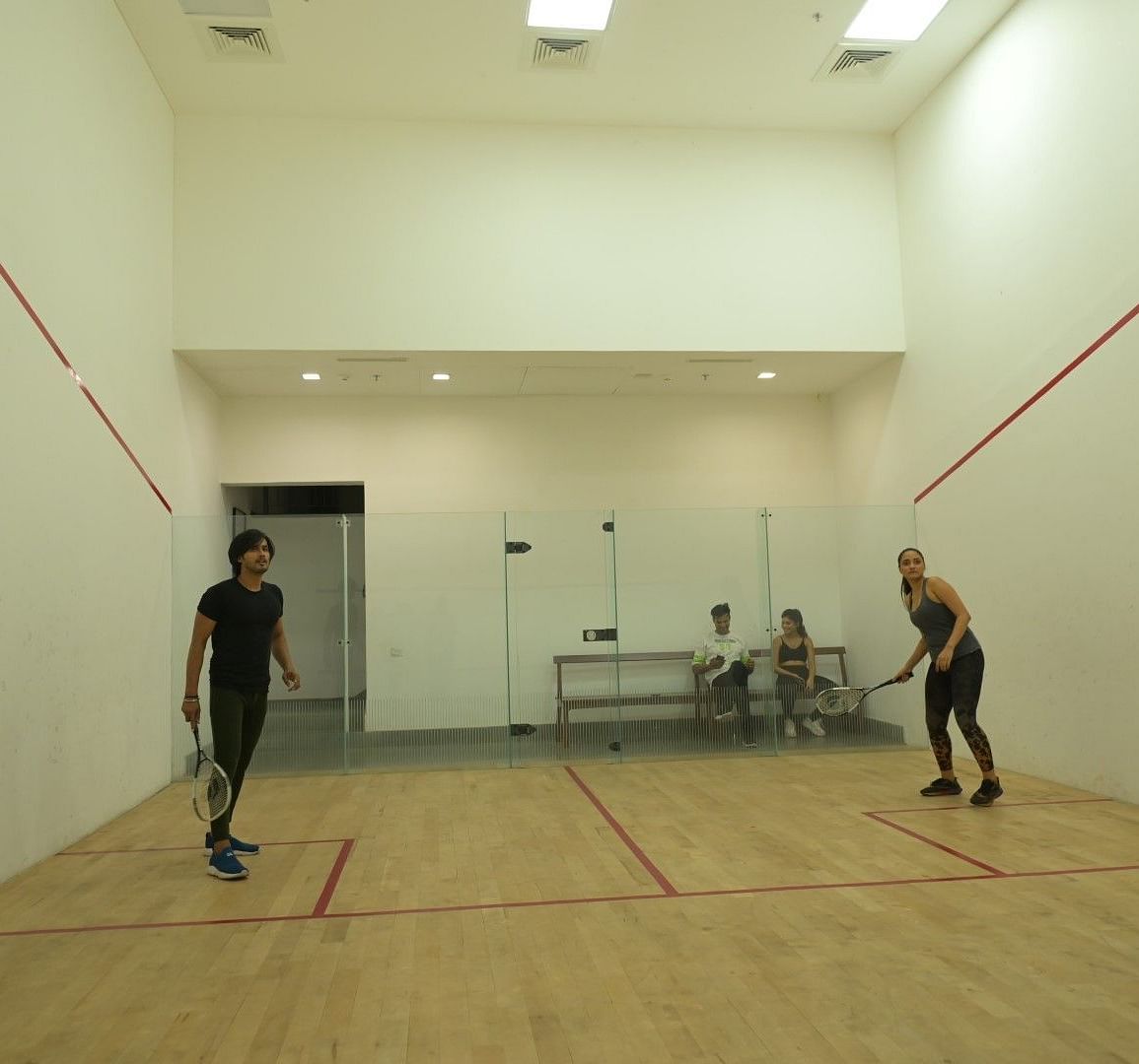 People playing in the squash court at Singalila Club