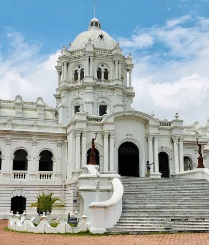 A wide shot of two-story white Ujjayanta Palace in Agartala.