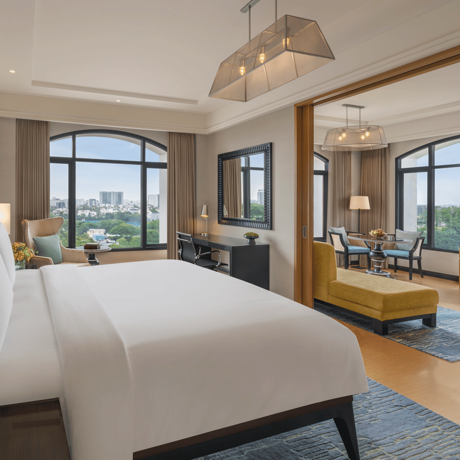 Room with double bed, armchair, and bedside lamps at The Raintree, St. Mary’s Road.