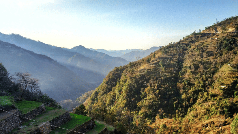 Landscape featuring sunlight on mountains with lush trees