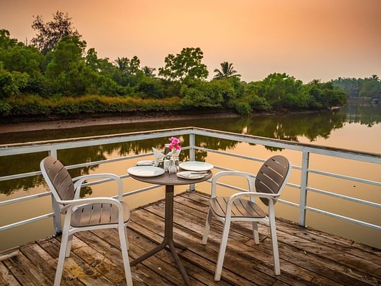 Evening Sunset at the outdoor seating area - Stone Wood Riverfront Resort, Siolim