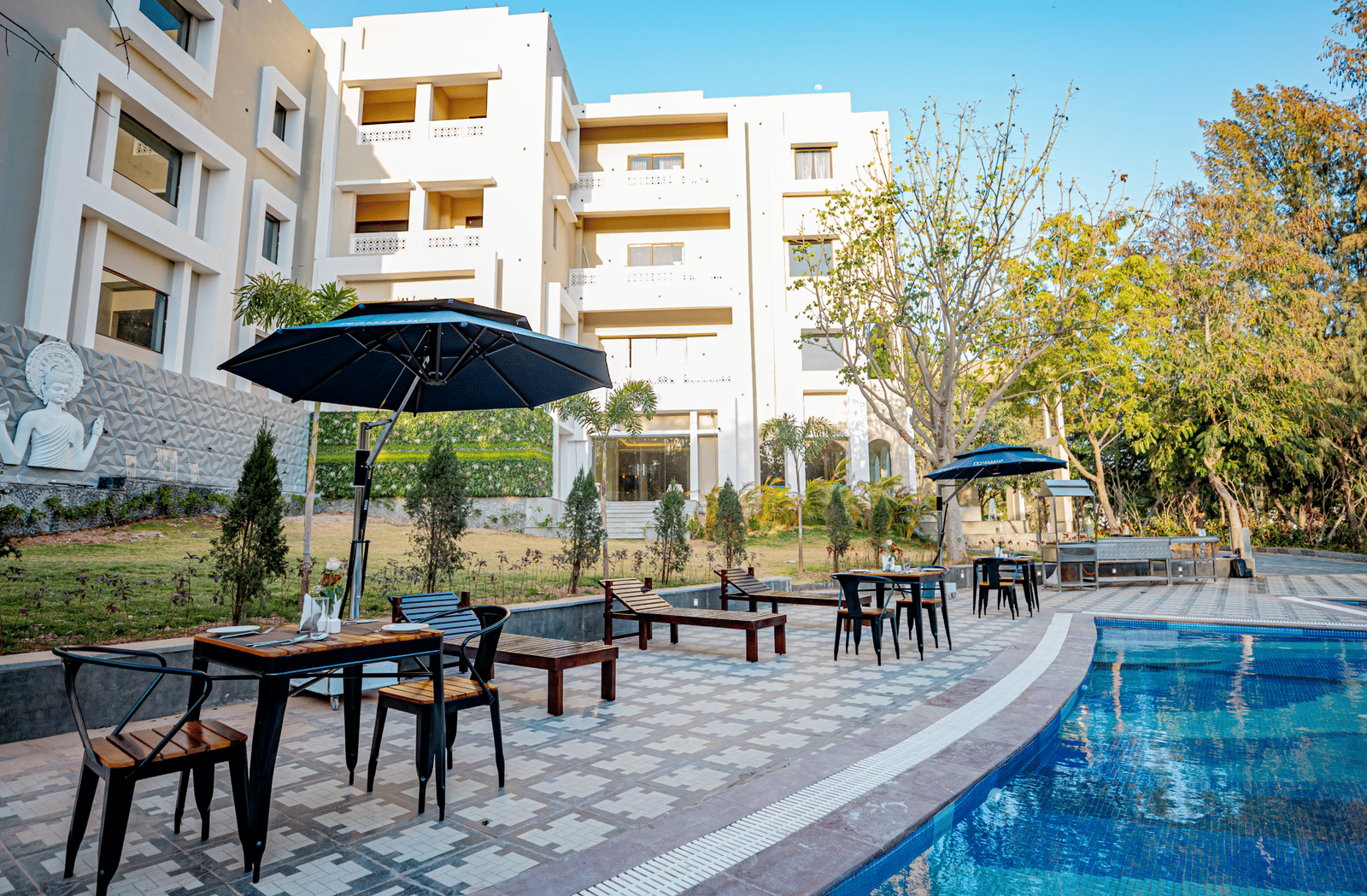 Image of a pool with seating area on the side at Essentia Luxury Resort and Spa, Udaipur