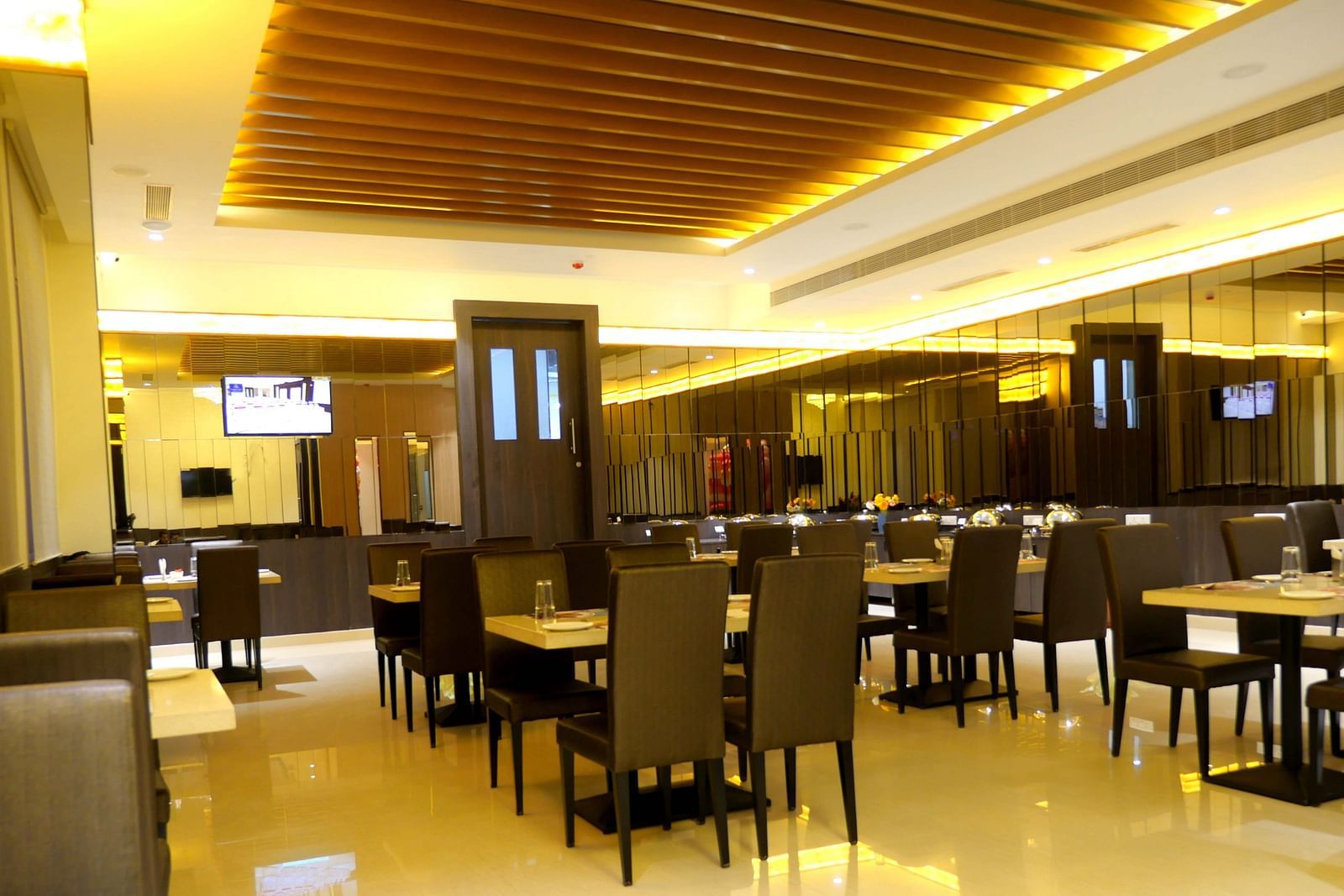 dining space of the restaurant Spice Treat with warm lights at ASR Parklane, Hosur