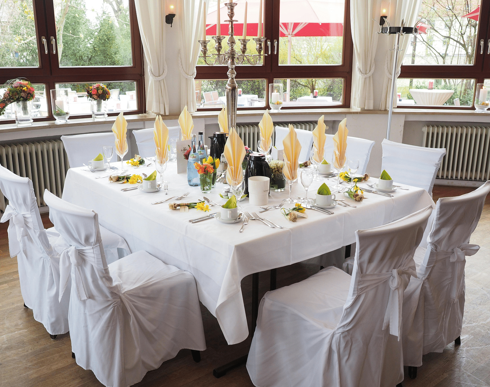 A table and chairs, elegantly decorated and arranged for an event.