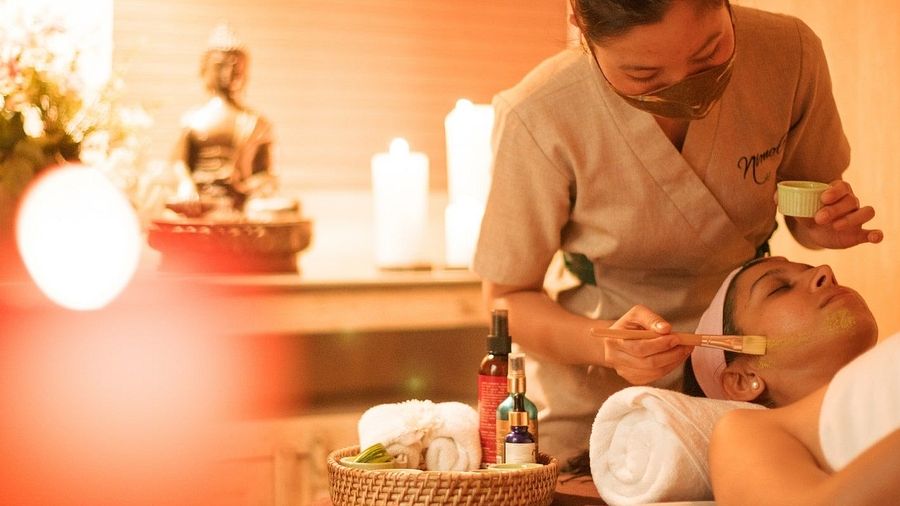 Woman lying on a bed for Spa at Karma Chalets.