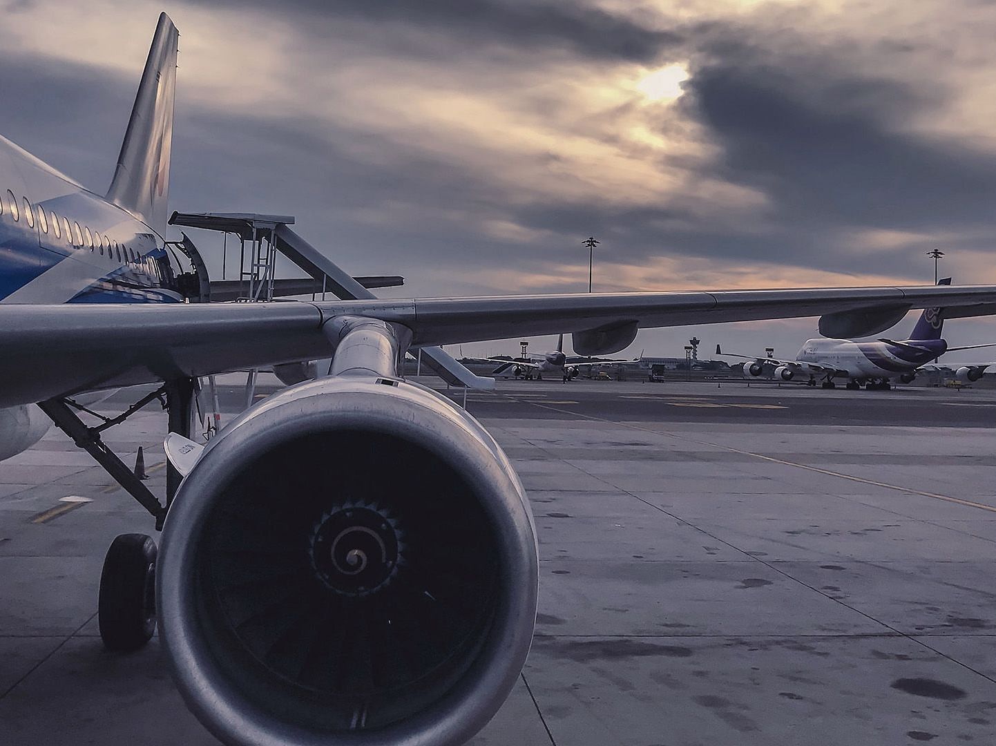 An image of a air plane on a run way on a cloudy day