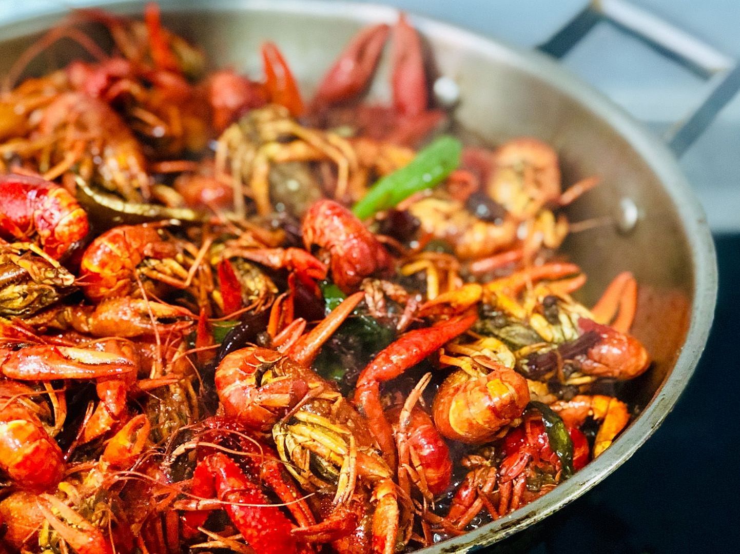 A tasty dish with lots of sea food and spices placed in a pan