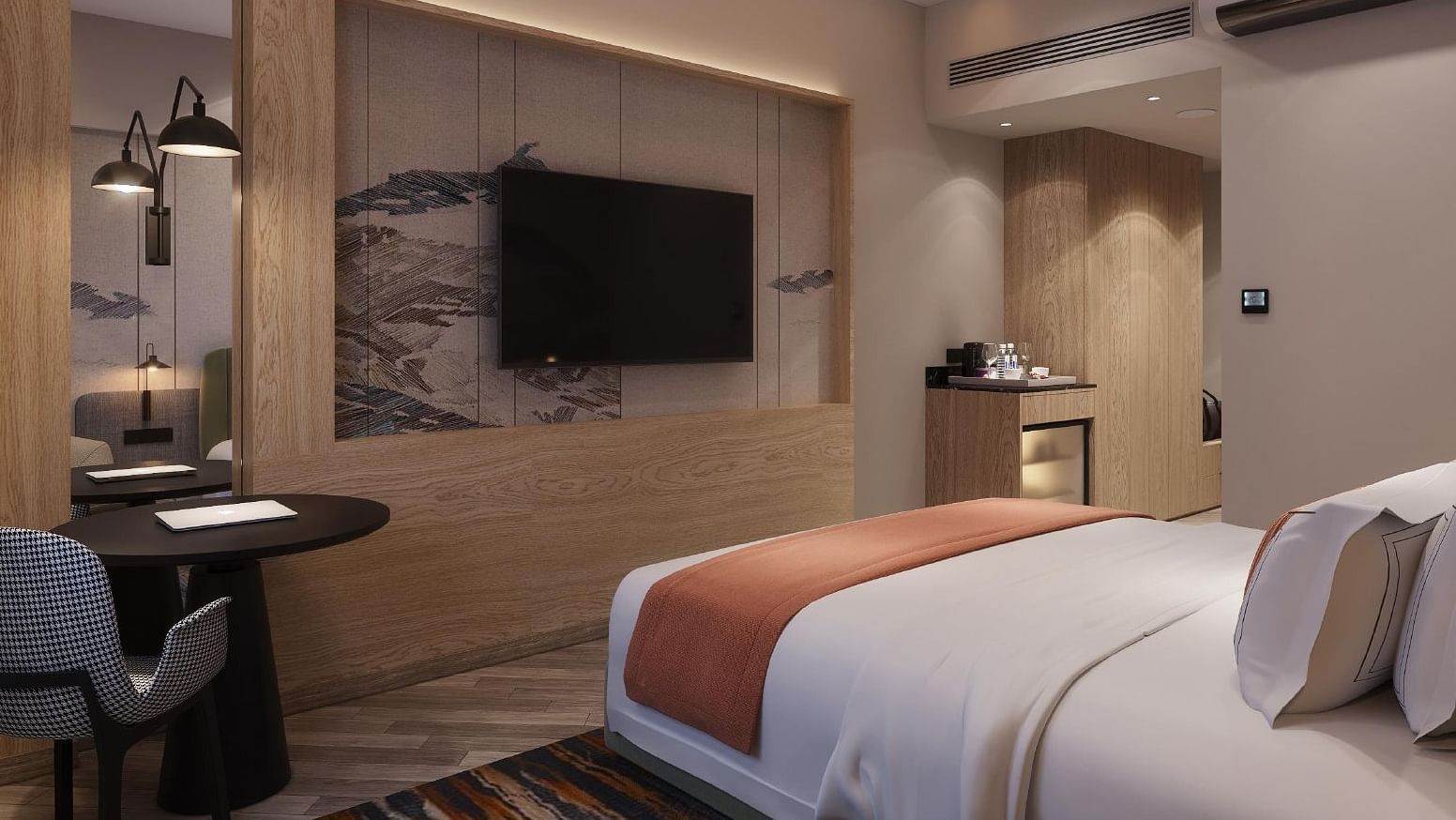 Image of a room with bed with a television in front.