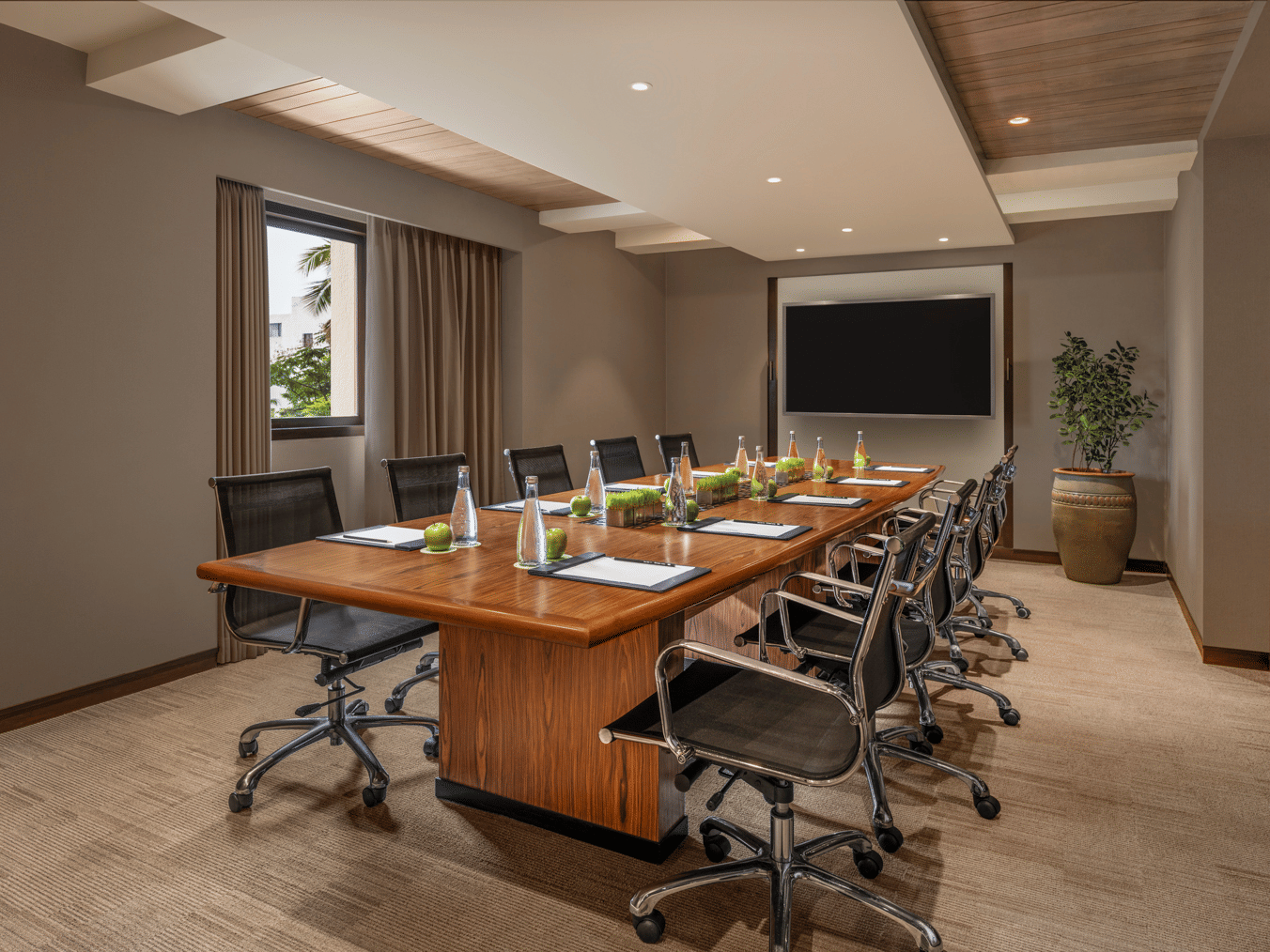 Meeting room with long table, chairs, and a presentation screen at The Raintree, St. Mary’s Road.