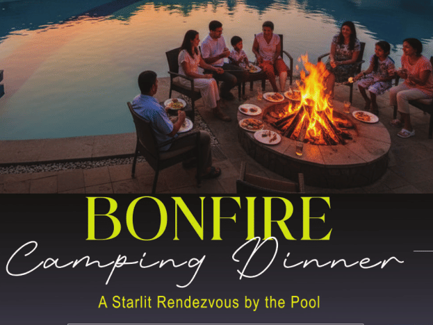 Poolside bonfire camping dinner setup under the evening sky at Vedic Village Spa Resort