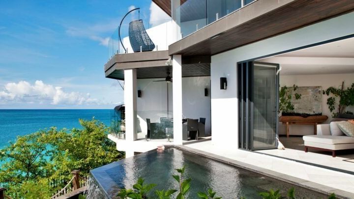 Oceanview terrace with an infinity pool and outdoor seating at Tamarind Hills Resort and Villas - Antigua.