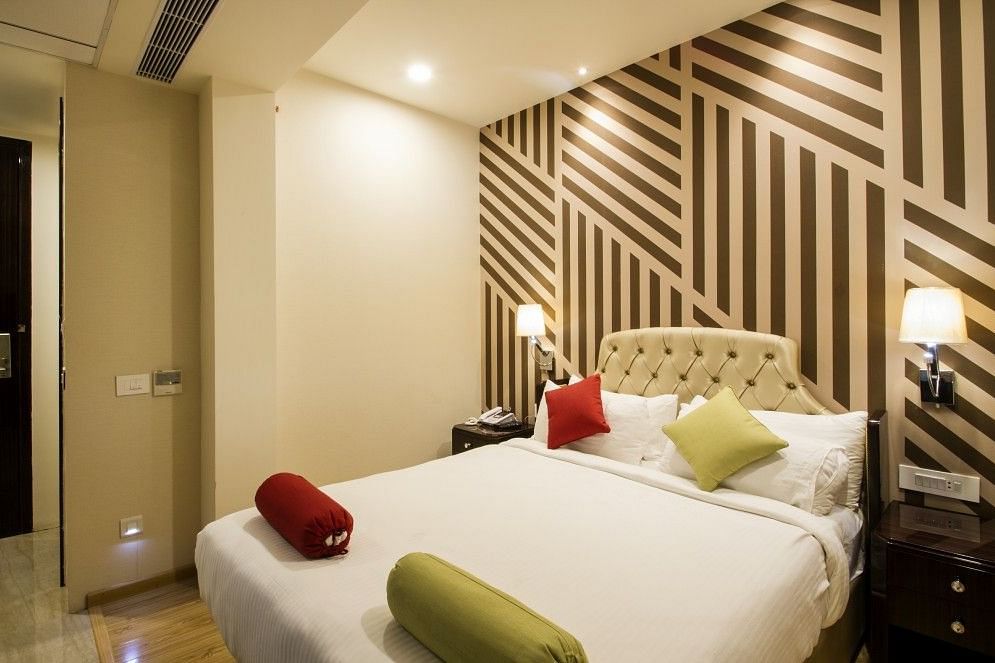 Standard room with bed and lamp on both the sides of the bed at Art Boutique Hotel, Hyderabad 