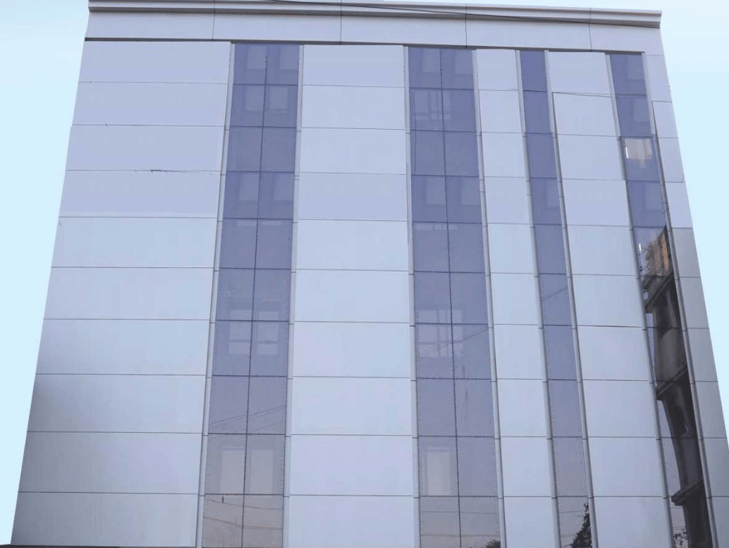 A digital rendering of a modern, red and white building with the 'Lords Inn' logo - Lords Hotels & Resorts