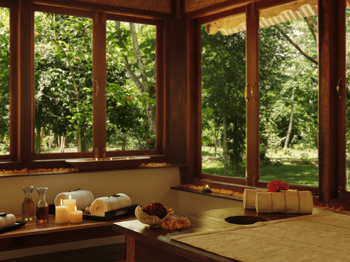 An overview of the interior of Oma Spa with a massage table and other things kept on the table at Barefoot at Havelock.