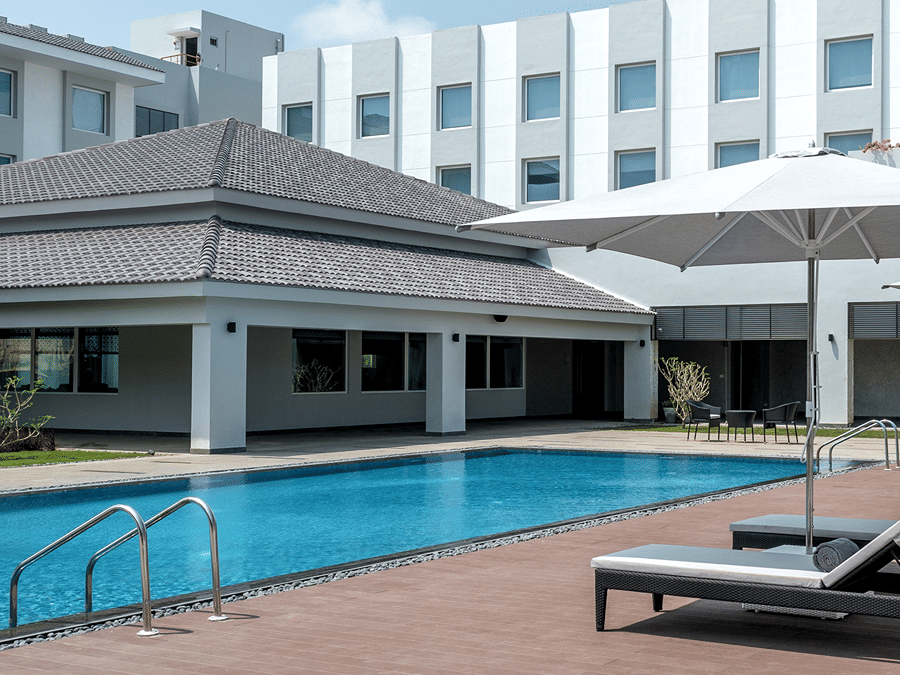 exterior of The Residency Towers Rameswaram with a swimming pool in front of it