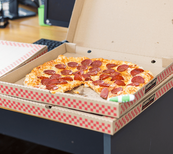 Pepperoni pizza delivered in an open box.