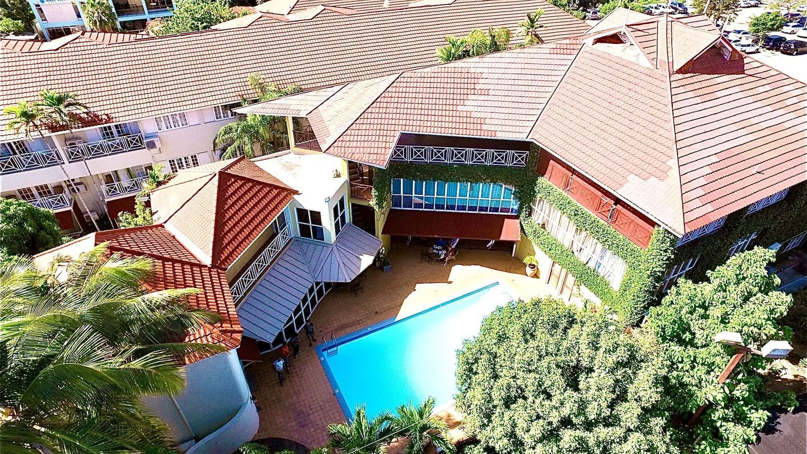 An aerial view of a resort featuring multiple buildings and a swimming pool | Altamont Court, Jamaica