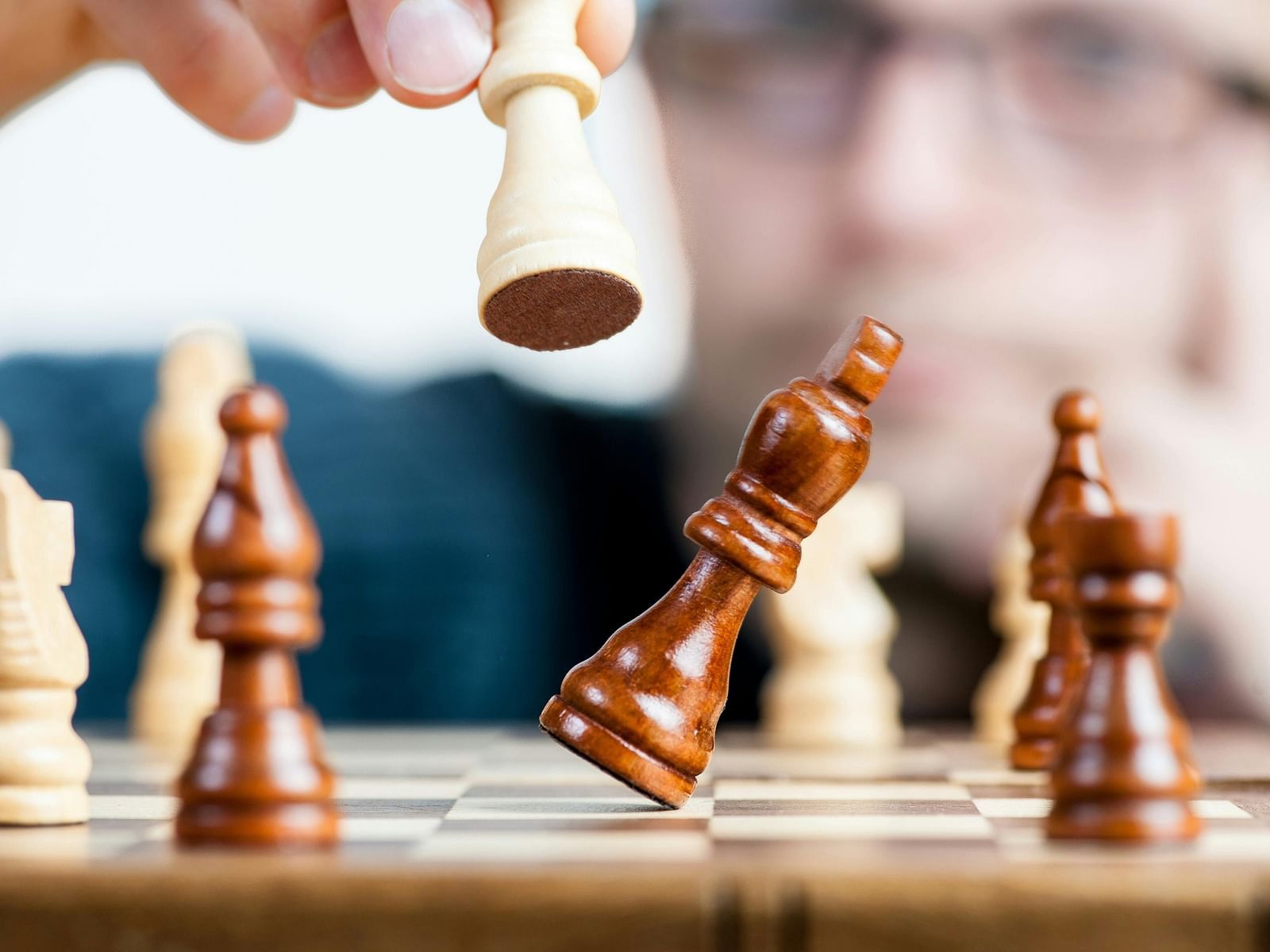 A close-up of a chessboard with wooden chess pieces.