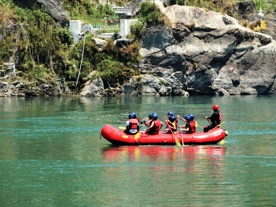 a group of people spotted in a rafting boat white river rafting in a river enclosed by mountain