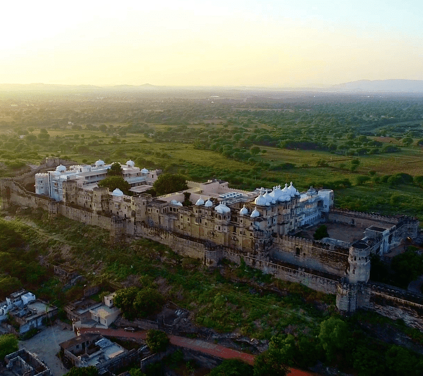 A drone shot of Sardargarh Heritage Fort seen during a serene sunrise