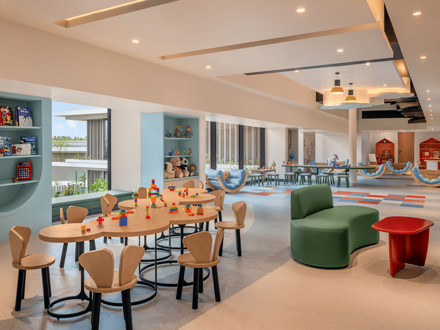 Kids' activity room with colourful seating and open shelving at The Residency Signature Madurai.