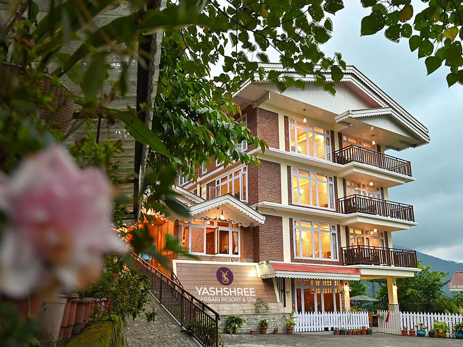 a beautiful facade image of the Yashshree Karbari Resort & Spa, Yangang with cloudy overcast skies in the background