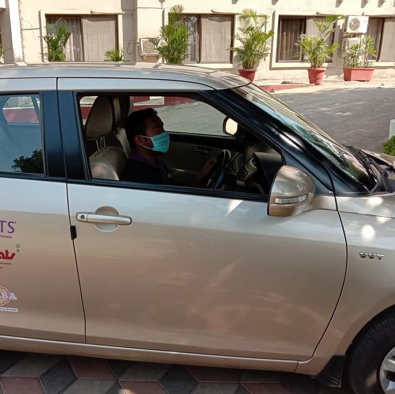 a close up shot of a car with the vits logo on it - VITS Hotels & Resorts