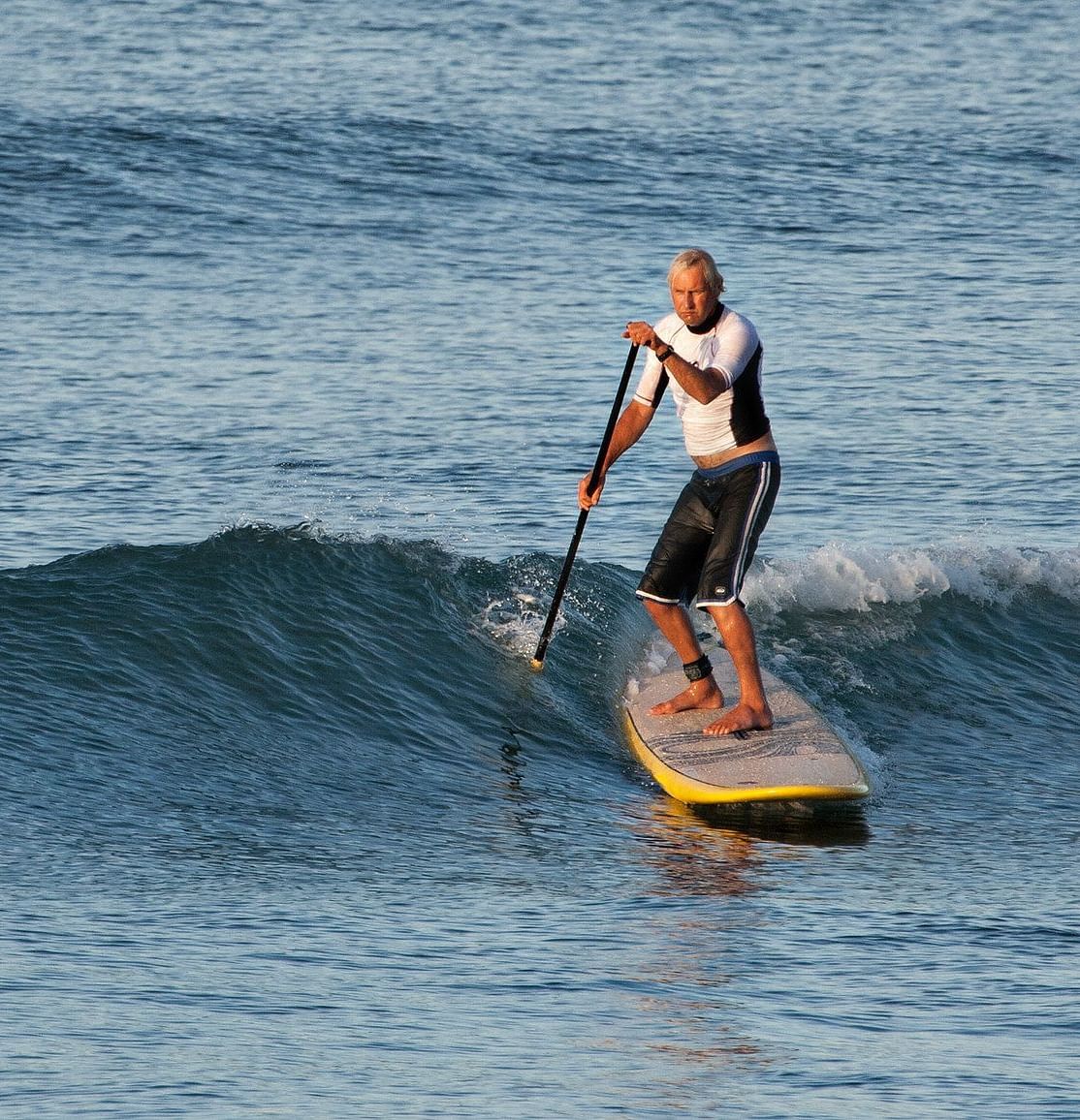 An image of a man surfing at the sea - Alibu Resort Nha Thrang