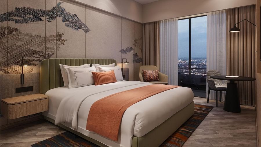 Image of room with bed and lamp besides the bed.