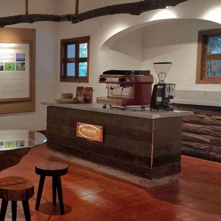 Interior of coffee museum with exhibits and a coffee machine.