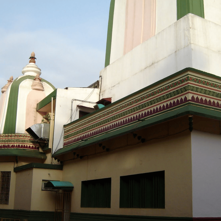 a close up shot of Shri Damodar Temple Zambaulim with blue sky in the background