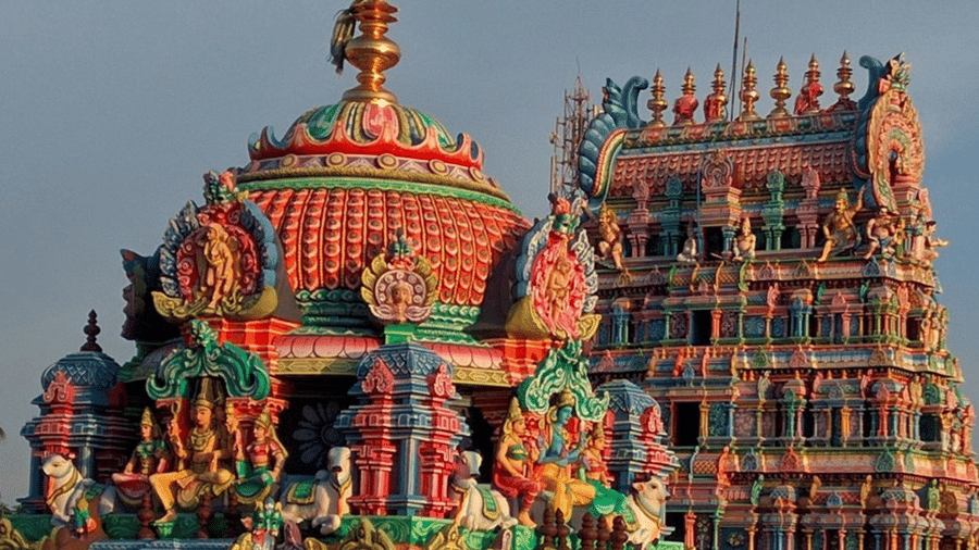 Domes and towers comprise the structure of Swamimalai Murugan Temple. Figures and patterns cover the surfaces.