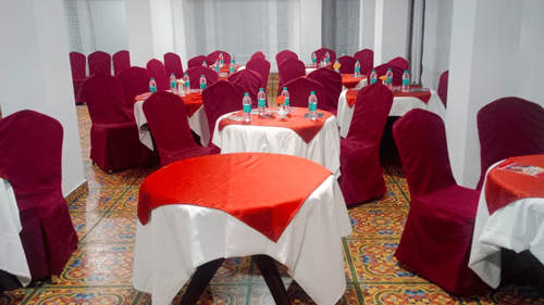 Interior of a hall with round tables surrounded by chairs