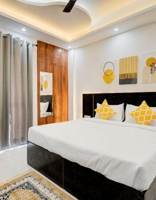 Stylish king room with contemporary furnishings at Turmeric Stays by Lime Tree Hotel, Greater Noida.