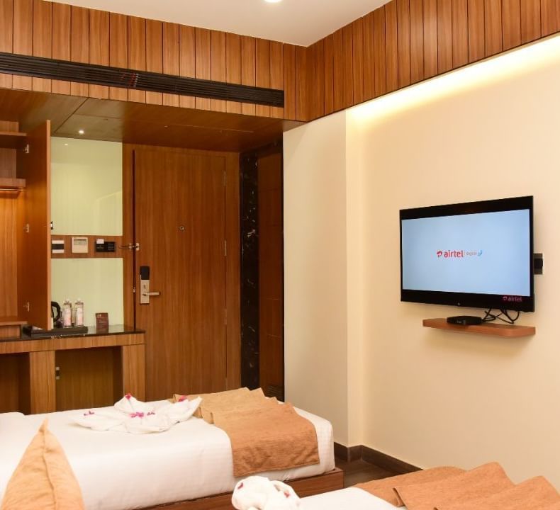 Twin beds with an LCD Television at TGI Felicity, Bangalore