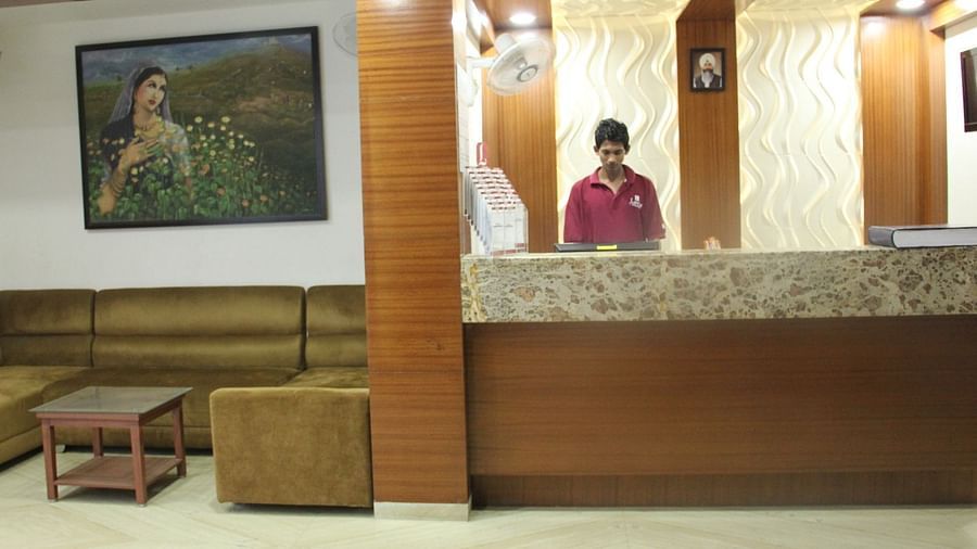 Hotel reception area with staff and wall art in the background