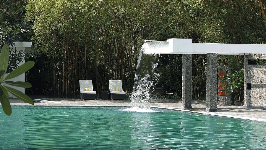 Side view of outdoor swimming pool surrounded by trees-Amanvana Spa Resort, Coorg - Luxury Resort 