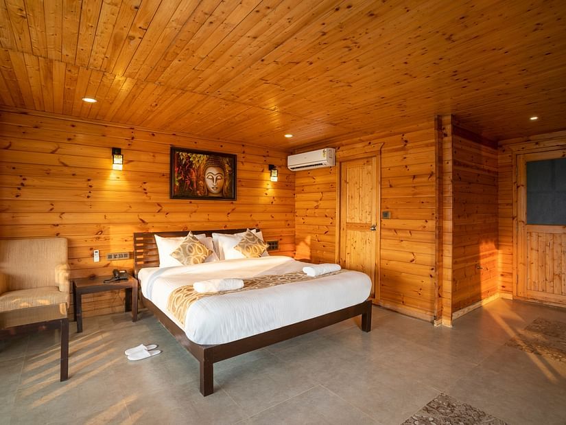The wooden interiors of the Family Cottage Bedroom - Stone Wood Riverfront Resort, Siolim