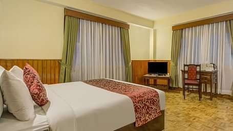 Image of a room with bed and windows on two sides of the room at Summit Tashi Ghang Heritage Resort, Pelling