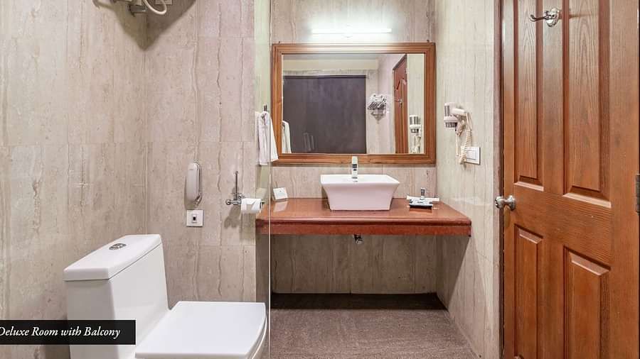 Washroom area of the deluxe room at Summit Barsana Resort & Spa, Kalimpong with a vanity