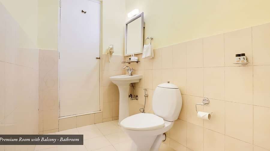 A commode, wash basin, and a mirror on the wall | Summit Newa Regency & Spa, Pelling