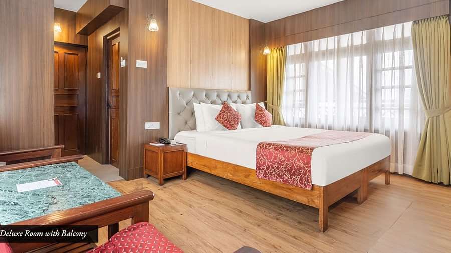 Image of a room with bed and large windows at Summit Tashi Ghang Heritage Resort, Pelling