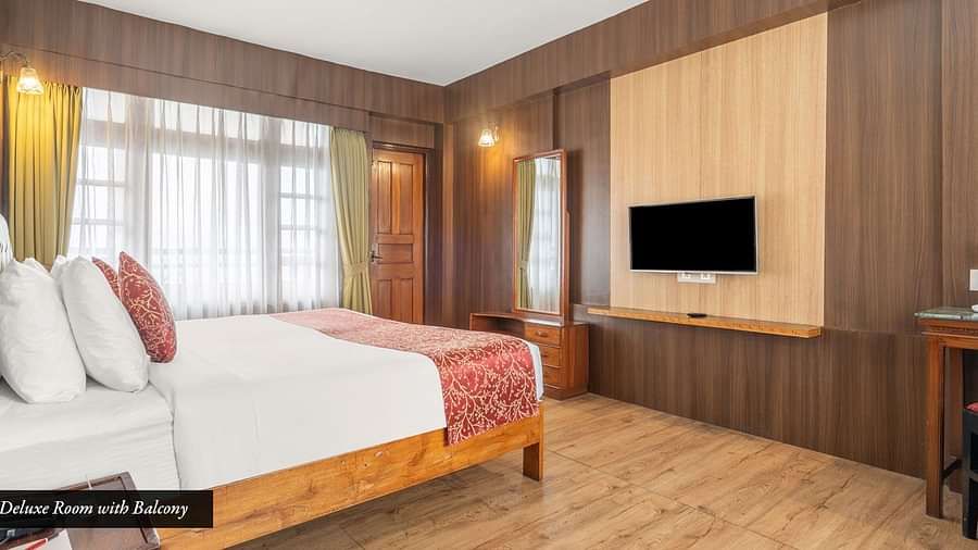 Image of a room with bed and television in front at at Summit Tashi Ghang Heritage Resort, Pelling