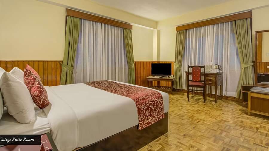 Image of a room with bed and windows on two sides of the room at Summit Tashi Ghang Heritage Resort, Pelling