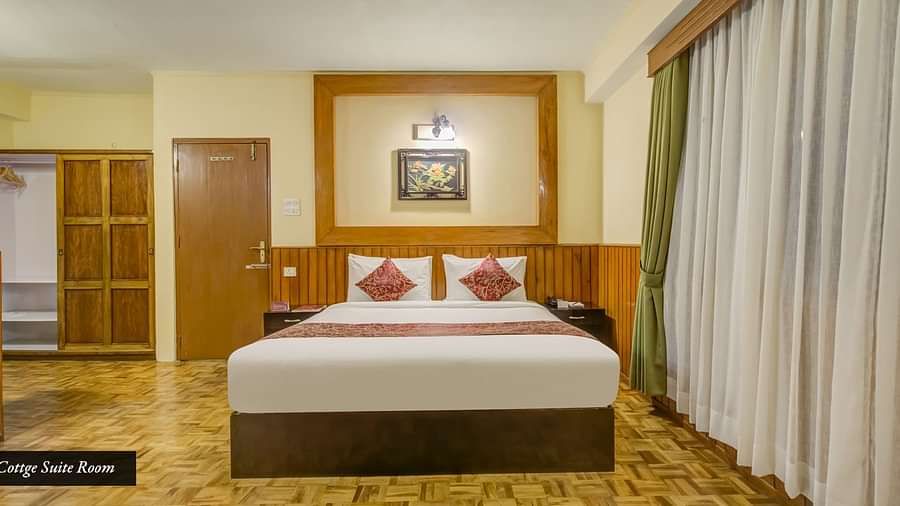 Image of a room with bed and large windows at Summit Tashi Ghang Heritage Resort, Pelling