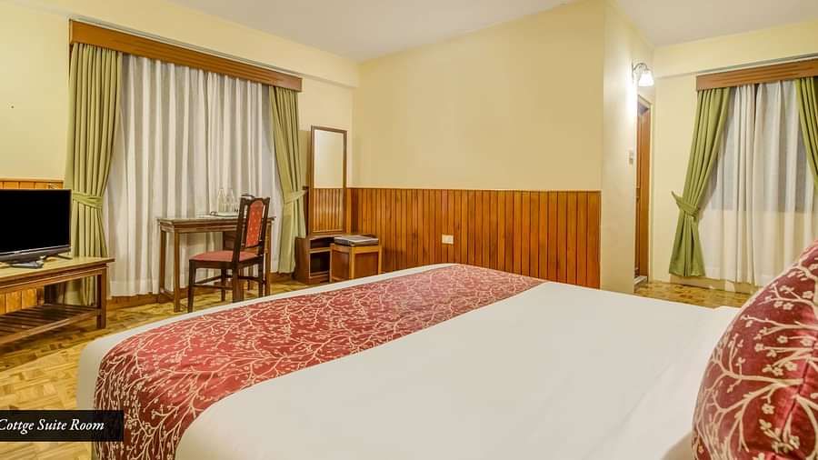 Image of a room with bed and a television in front at Summit Tashi Ghang Heritage Resort, Pelling
