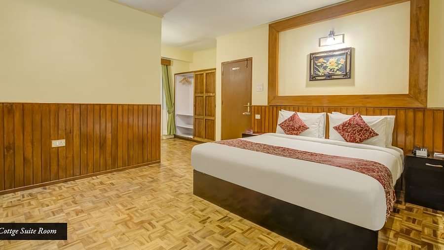 Image of a room with bed and wooden wall panels at Summit Tashi Ghang Heritage Resort, Pelling